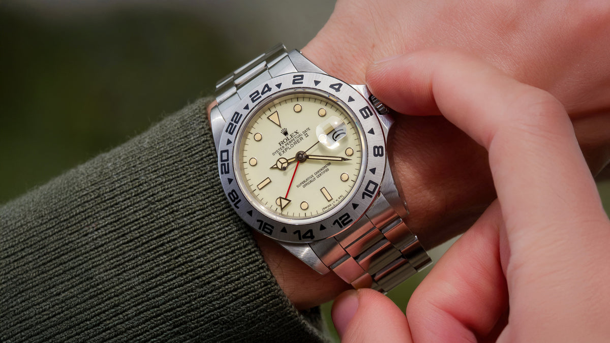 Hairspring article: Explorer II 16550 on the wrist, white dial aged to cream with white-gold surrounds and red 24-hour hand. · Photo: Hairspring · © Hairspring, used with permission · Source: https://hairspring.com/blogs/finds/cream-dial-16550-rolex-explorer-ii-1